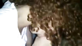 Duda Scavo, a young redhead with curly hair, sucking off her boyfriend