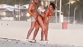 amateur couple having sex on the beach during the day in Rio de Janeiro