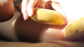 Putting a banana in her pussy and another in her honeyed ass