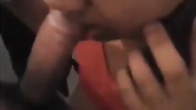 Shamelessly talking to her husband on her cell phone while sucking her lover's cock