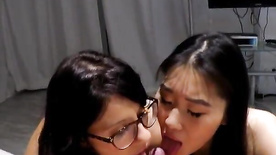 Sexy asian girls making a male cum on double blowjob