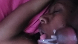 Married black woman drinking milk in her face while she sleeps