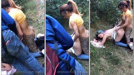 Transvestite fucking young blue-haired girl on all fours in the woods