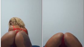 Livia Vitória from onlyfans in red lingerie throwing her ass in front of the camera.