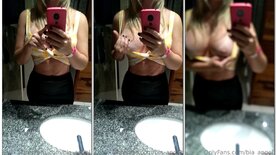 Bia Angel showing her breasts in the bar's bathroom mirror