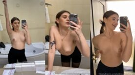 Young Lola Taylor in front of the mirror showing off her small, hard tits